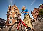 A woman on a bicycle in the Speicherstadt.