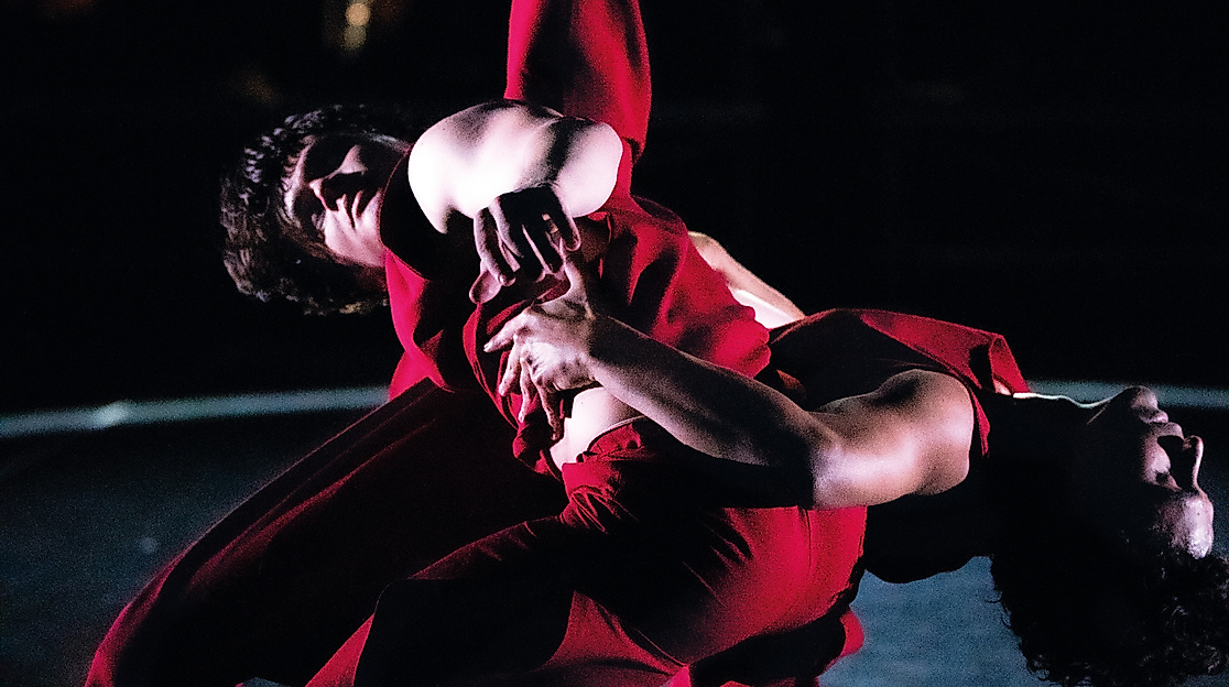 Two dancers entwined.