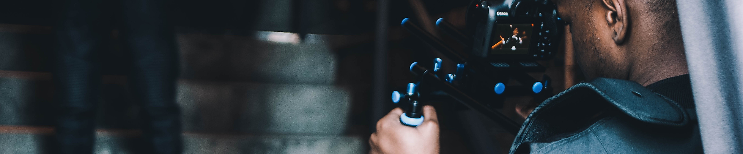 Kameramann filmt eine Person auf einer Treppe bei Innenaufnahmen in urbanem Setting