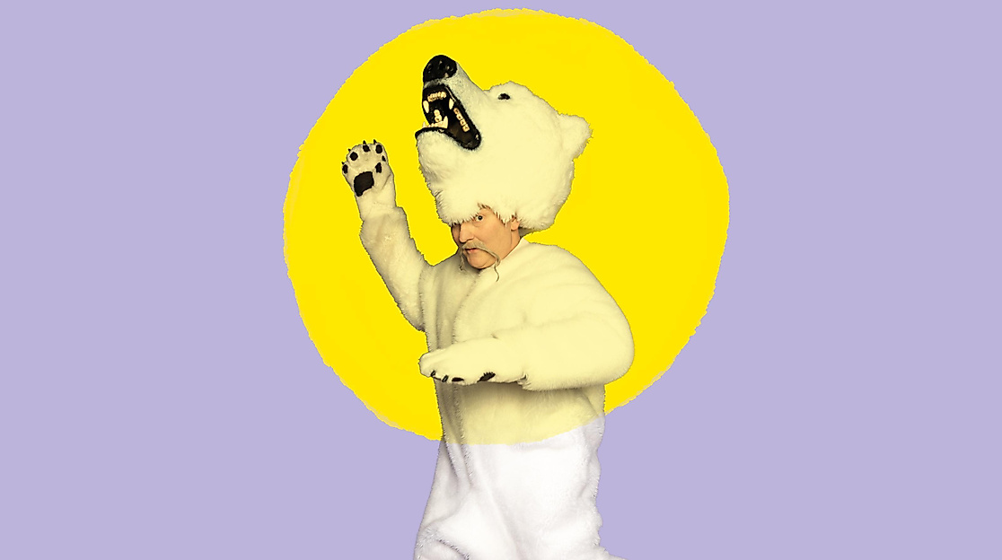 A person perceived as male, dressed in a polar bear costume, is moving against a lilac-colored background with a painted yellow sun.