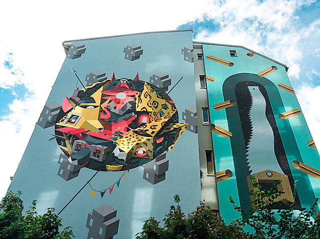 Großflächige Street-Art-Fassade im Gängeviertel Hamburg mit bunten Motiven auf modernem Gebäude