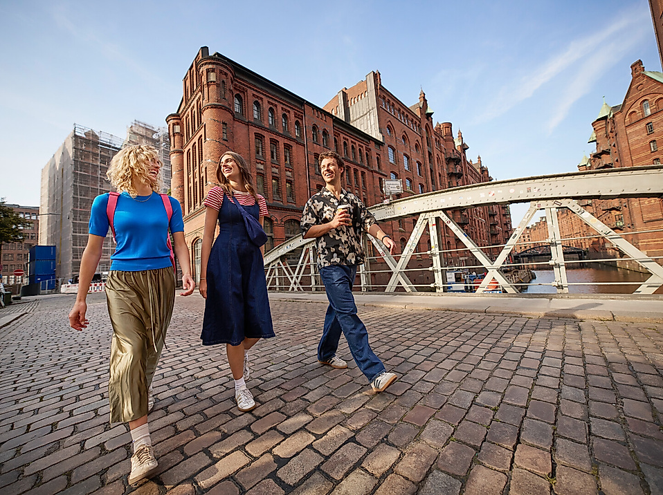 Three young adults are out for a walk in the Speicherstadt