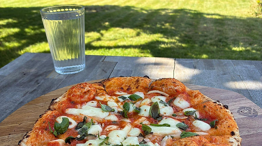 A pizza on a garden table