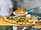 Orientalischer Flammkuchen mit Dipp im Restaurant Morgenland in Hamburg-Winterhude auf Holzbrett serviert